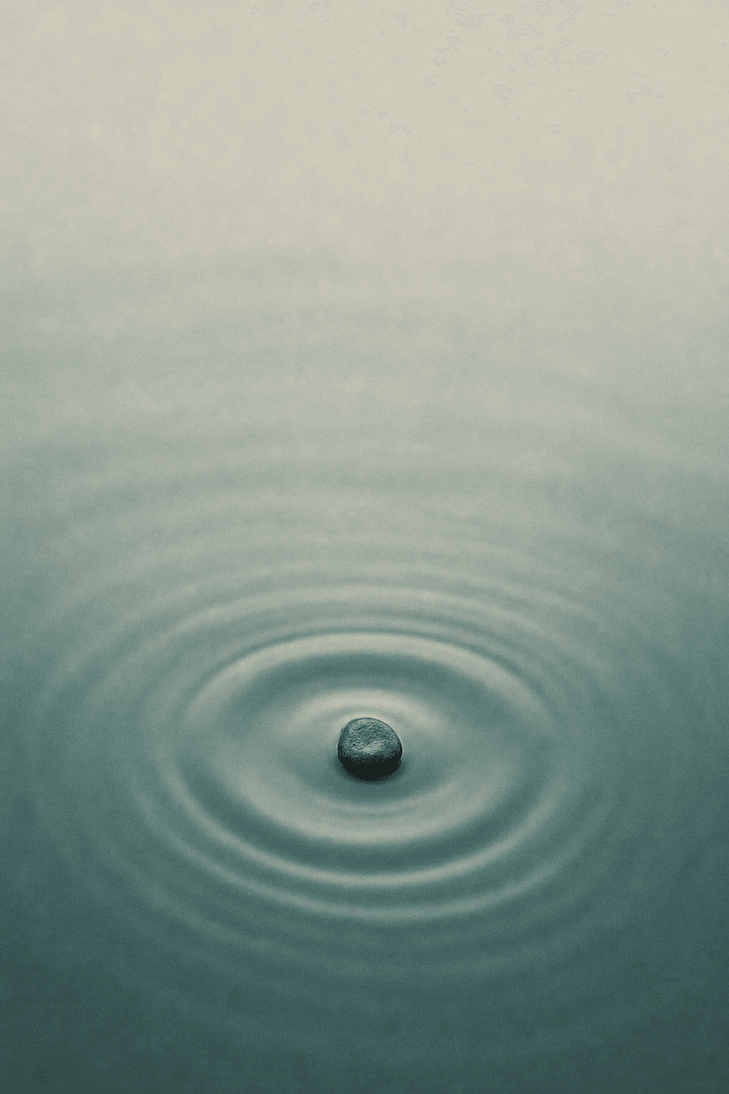 Concentric ripples on calm teal water